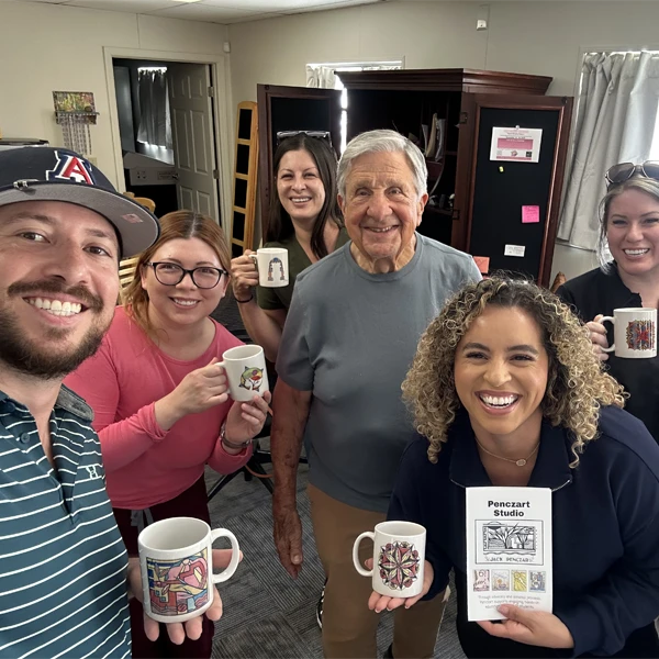 The Buena Vida Dental team posing with the owner of an art studio
