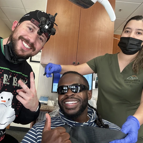Dr. Carlos and a patient posing for a selfie