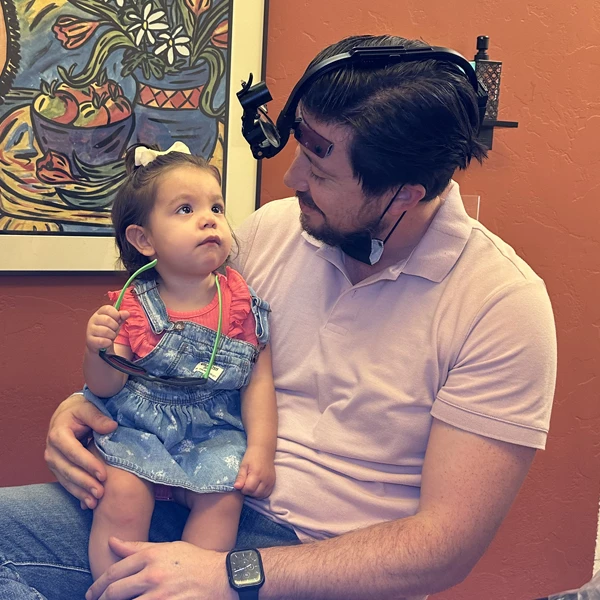 Dr. Carlos with a young pediatric patient