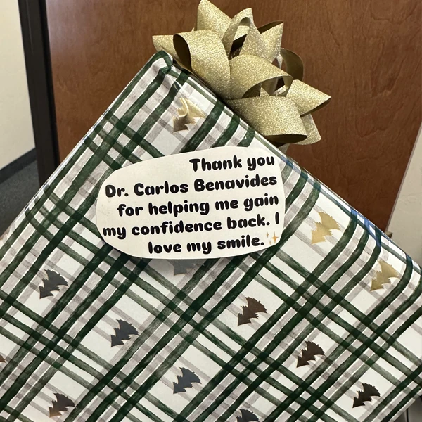 A holiday gift from a patient with a tag reading "Thank you Dr. Carlos Beavides"