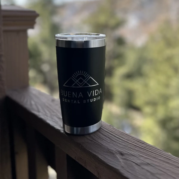 A tumbler with the Buena Vida Dental Studio logo